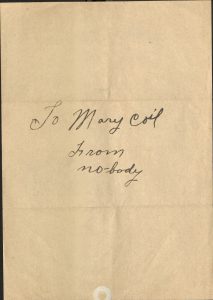 Paper with handwritten text stating "To Mary Coil, From nobody"