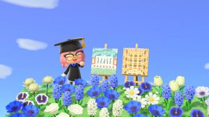 Screen capture of Animal Crossing avatar beside two paintings of Eisenhower and Peabody Library