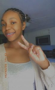 Picture of J'Naya Harris smiling and holding up two fingers in a peace sign. Image courtesy of J'Naya Harris