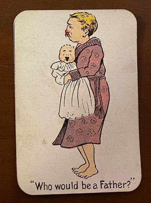 Playing game card showing a father holding a crying child.