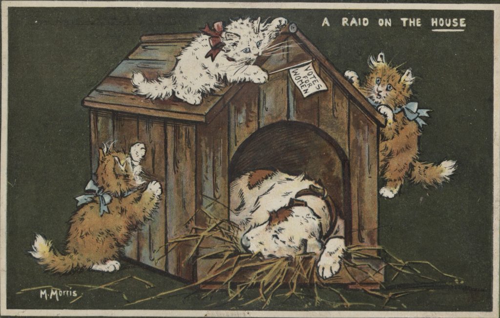 A postcard from the 1910s showing three cats climbing a dog house while the dog sleeps. 