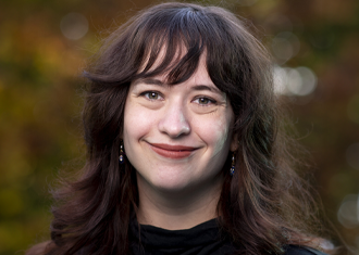 portrait of Michelle Fitzgerald on a blurry fall foliage background