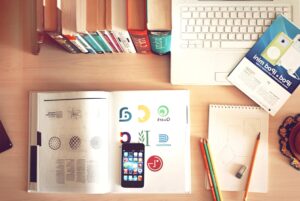 a picture of books by a laptop on a desk from https://pixnio.com/objects/computer/mobile-phone-book-laptop-computer-pencil-notepad-desk-office-paper